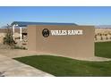 Wales Ranch community entrance sign with landscaping and a covered seating area at 1893 E Harness Ln, San Tan Valley, AZ 85140