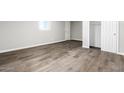 Simple bedroom with wood-look floors and a white closet at 9195 N Diffin Rd, Florence, AZ 85132