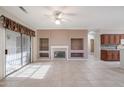 Living room with tile floors, fireplace, and access to backyard at 15805 W Arrowhead Dr, Surprise, AZ 85374