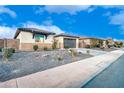 Front view of a house with a two-car garage and nicely landscaped yard at 17316 W Seldon Ln, Waddell, AZ 85355