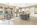 Kitchen features a large island, breakfast nook, and white cabinetry at 3291 E Cherrywood Pl, Chandler, AZ 85249