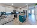 Modern kitchen featuring granite countertops and white cabinets at 7439 W Tonopah Dr, Glendale, AZ 85308