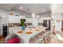 Modern kitchen with white cabinets, large island, and stainless steel appliances at 6240 S Dean Rd, Buckeye, AZ 85326