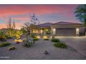 Attractive single-story home with desert landscaping and two-car garage at 9240 E Broken Arrow Dr, Scottsdale, AZ 85262