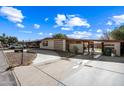 Street view of a single-story home with a driveway, landscaping, and a gated entryway at 1219 E Barcelona Ave, Casa Grande, AZ 85122