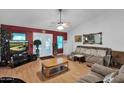 Living room featuring brown sofas, wood floors, and a view into the kitchen at 3401 N Dakota St, Chandler, AZ 85225
