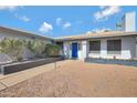 Inviting front entry with a blue door and landscaping at 4832 W Caron St, Glendale, AZ 85302