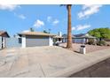 Attached two-car garage with a long driveway at 4832 W Caron St, Glendale, AZ 85302