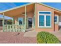 Well-maintained manufactured home with a covered porch and desert landscaping at 8500 E Southern Ave # 548, Mesa, AZ 85209