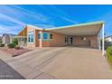 Tan manufactured home with carport and easy access at 8500 E Southern Ave # 548, Mesa, AZ 85209