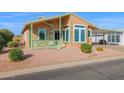 Charming manufactured home with covered porch and neatly landscaped yard at 8500 E Southern Ave # 548, Mesa, AZ 85209