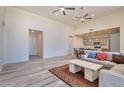 Open-concept living area with a comfortable sectional sofa and view into the kitchen at 1298 W Calle Tuberia --, Casa Grande, AZ 85194