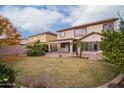 Large backyard with grassy area, patio, and mature trees at 3019 E Denim Trl, San Tan Valley, AZ 85143