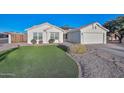 One-story home with artificial turf, stone pathway, and a wooden fence at 3061 N Platina Cir # N, Mesa, AZ 85215