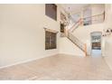 Spacious living room with high ceilings, hardwood floors, and a grand staircase at 322 E Caribbean Dr, Casa Grande, AZ 85122