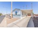 Single-wide manufactured home with covered carport and street view at 5201 W Camelback Rd # A187, Phoenix, AZ 85031