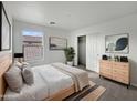 Bright bedroom with a queen bed, dresser, and large closet at 4042 W Kirkland Ave, San Tan Valley, AZ 85144