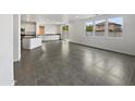 Kitchen with a large island, white cabinets, and dark countertops at 4042 W Kirkland Ave, San Tan Valley, AZ 85144