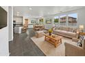 Open floor plan living room with a beige couch and a kitchen with an island at 4042 W Kirkland Ave, San Tan Valley, AZ 85144