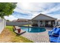 Relaxing backyard with a kidney-shaped pool, patio furniture, and grassy area at 4112 E Tanglewood Dr, Phoenix, AZ 85048