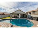 Stunning pool area with a large kidney shaped pool and spacious patio at 4112 E Tanglewood Dr, Phoenix, AZ 85048