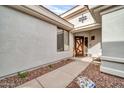 View of the front entry with a modern door and walkway at 2410 W Muirfield Dr, Anthem, AZ 85086