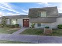 Gray exterior condo with brown double doors and landscaping at 4937 N Granite Reef Rd, Scottsdale, AZ 85251