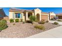 Front yard view of a single-story house with a two-car garage and desert landscaping at 7266 W Meadowlark Way, Florence, AZ 85132