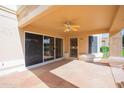 Covered patio with sliding glass doors and ceiling fan at 8431 W Utopia Rd, Peoria, AZ 85382