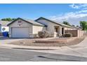 Front view of charming house with landscaped yard and brick accents at 21617 N 30Th Ave, Phoenix, AZ 85027