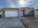 New single-story home with a white garage door and gray exterior at 2297 E Wagon Wheel Ln, San Tan Valley, AZ 85140