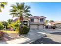 Two-story house with a three-car garage and lush landscaping at 5322 N Oro Vista Ct, Litchfield Park, AZ 85340