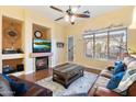 Cozy living room with a fireplace, hardwood floors, and leather furniture at 913 N John Way, Chandler, AZ 85225