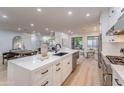 Open concept kitchen with island seating and views into living room at 16593 N 104Th St, Scottsdale, AZ 85255