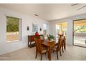 Bright dining area with wooden table and access to backyard at 16933 W Oasis Springs Way, Surprise, AZ 85387