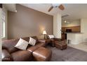 Living room with leather furniture and open kitchen view at 280 S Evergreen Rd # 1270, Tempe, AZ 85288
