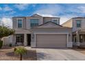 Two-story house with a two-car garage and well-maintained landscaping at 33242 N Jamie Ln, San Tan Valley, AZ 85144