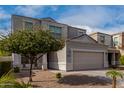 Two-story house with a two-car garage and mature tree in front at 33242 N Jamie Ln, San Tan Valley, AZ 85144