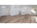 Open living area with kitchen island and wood-look flooring at 3956 N 151St Dr, Goodyear, AZ 85395