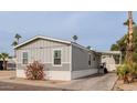 Side view of gray manufactured home with carport at 625 W Mckellips Rd # 213, Mesa, AZ 85201