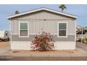 Rear view of gray manufactured home with red flowers at 625 W Mckellips Rd # 213, Mesa, AZ 85201