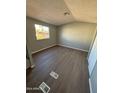 Spacious bedroom with wood-look flooring and large window at 652 S Ellsworth Rd # 170, Mesa, AZ 85208