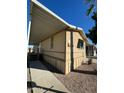 View of the home's exterior, showcasing the carport and walkway at 652 S Ellsworth Rd # 170, Mesa, AZ 85208