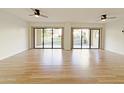 Bright living room with wood-look flooring and sliding glass doors to a patio at 10330 W Thunderbird Blvd # A137, Sun City, AZ 85351