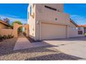 View of the home's side elevation, showcasing a walkway and gate at 10633 E Michigan Ave, Sun Lakes, AZ 85248