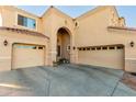Two-story house with a three-car garage and arched entryway at 17769 W Alexandria Way, Surprise, AZ 85388