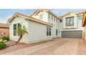 Two-story house with a gray exterior, landscaped front yard, and a brick driveway at 3844 E Frances Ln, Gilbert, AZ 85295