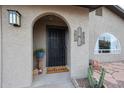 Inviting front entrance with arched doorway and welcome mat at 723 W 5Th Ave, Apache Junction, AZ 85120