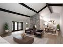 Open living and dining area with stone fireplace and high ceilings at 7331 E Valley Vista Dr, Scottsdale, AZ 85250