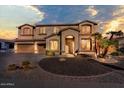 Two-story house with desert landscaping and a three-car garage at dusk at 2144 E Firestone Dr, Chandler, AZ 85249